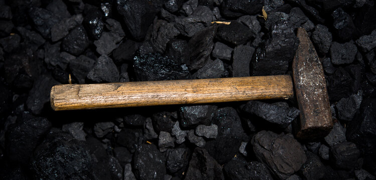 Top view of a coal mine mineral black for background with shovel. Used as fuel for industrial coke.