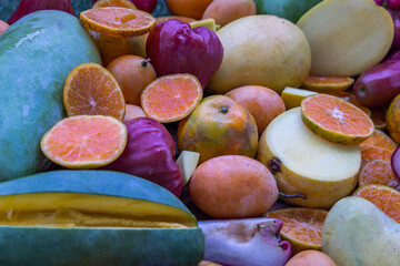Variety of fresh assorted fruits on the old wooden table. Assorted fruits colorful background.