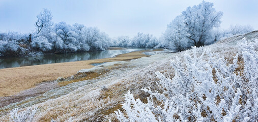 Scenic country road, in remote rural area in winter, covered with frost
