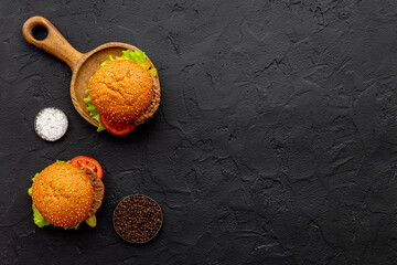 Homemade burgers on serving board. Fastfood meal background