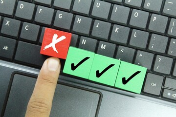 wooden cubes with right and wrong marks. the concept of check marks