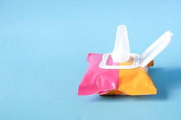 Cleansing wet wipes on blue with copy space 