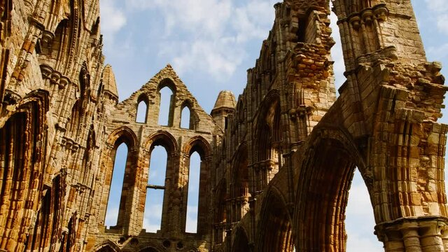Cinematic View of the ruins of Whitby Abbey, a 7th-century Christian monastery and Benedictine abbey in Yorkshire, England, UK