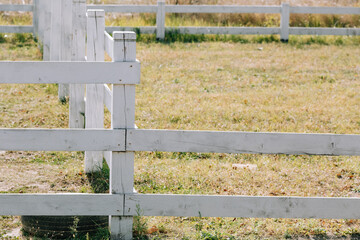 A closeup shot of a white fence. Rustic Farm.