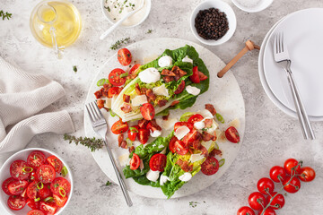romaine lettuce topped with bacon tomato parmesan, sauce. healthy keto paleo diet lunch
