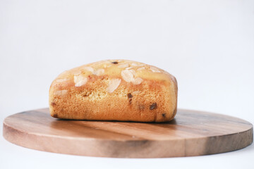 slice of bakery cake on chopping board on white 
