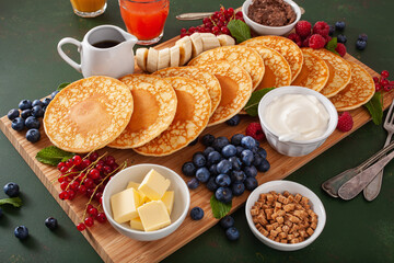 american pancake board with berries maple syrup butter