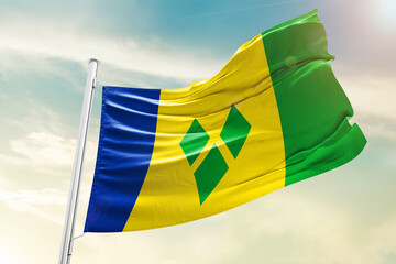 Saint Vincent and the Grenadines national flag waving in beautiful clouds.