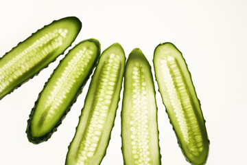 Cucumber green slices pattern isolated on white background. Creative cucumbers wallpaper, food backdrop design