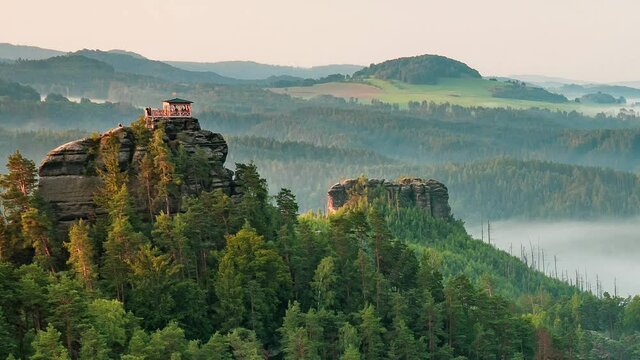 Breakfast or morning picnic of tourists group on popular lookout tower Mariina vyhlidka. The significant viewpoint in Bohemian Switzerland National Park, Czech Republic. Slow motion or timelapse.