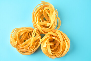 Pasta, macaroni, spaghetti isolated on blue background, flat lay, clipping path