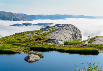 Fototapeta na wymiar Facing to lysefjord in a foggy morning on the way to Preikestolen, Norway
