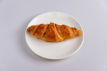 Delicious croissants and coffee cup on wooden plate. Freshly baked.