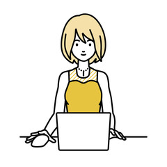 デスクで座ってPCを使っているドレスの女性