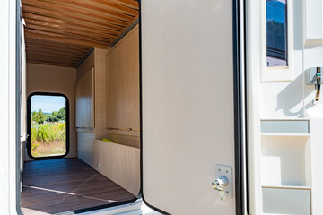 Spacious trunk of white caravan, on a sunny day