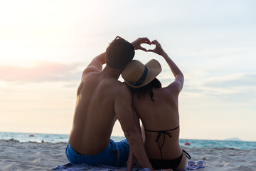 Lover Young Asian happy couple relax on the beach, Couple in love honeymoon vacation and travels concept.Romantic lifestyle. Thailand. Summer,Travel, Valentine Concept.