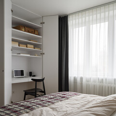 Simple bedroom with desk in wardrobe