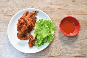 deep fried shrimp with flour on plate dipping spicy chili sauce