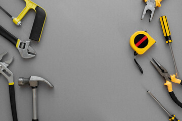Flat lay composition with construction and home repair tools tools on grey background, space for...