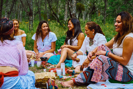 Happy Women Talking During Ritual In Forest