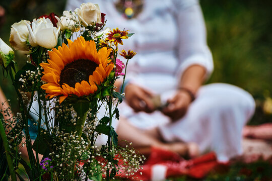 Closeup Of Fresh Flowers With Woman In Forest