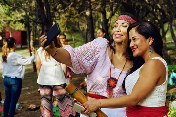 Woman Taking Selfie Through Smartphone With Friend