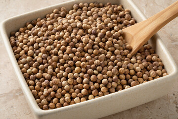 Bowl with dried organic coriander seeds close up 