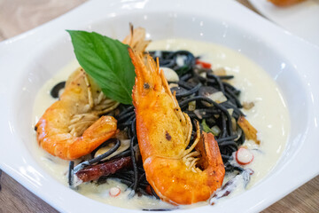 Shrimp seafood with black spaghetti.