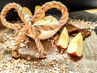 Porridge with fruit. Breakfast. Healthy food. Apple on a dark background with decoration