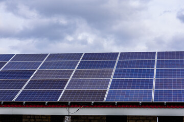 Fototapeta premium Many solar panels on a roof of building