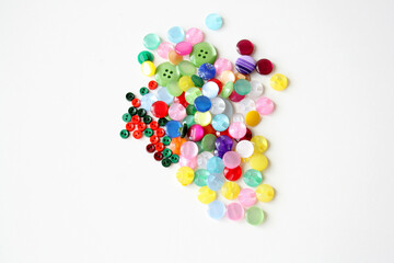 Multicolored sewing buttons on a white background. Sewing accessories for decoration and sewing clothes.