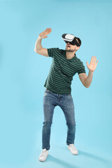 Man using virtual reality headset on light blue background