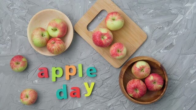 Apple is a national holiday on October 21. Red apples on a gray background. Flat lay
