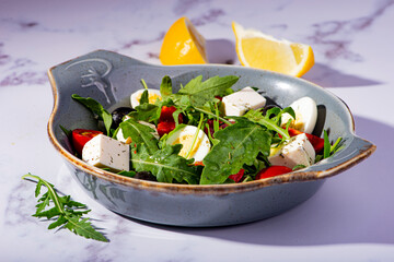 salad with arugula, cheese, quail egg and cherry