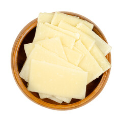 Thin Grana Padano cheese slices, in a wooden bowl. Italian hard cheese, similar to Parmesan, crumbly-textured, with strong savory flavor and slightly gritty texture, made from unpasteurized cow milk.