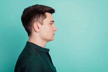 Profile side photo of serious businessman look empty space isolated over teal background