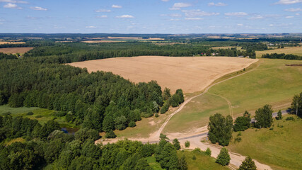 Village among green forest, peace and quiet. The harvest was removed. Countryside background.