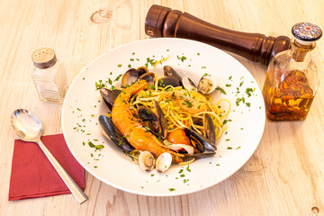 Italian spaghetti a la marinera recipe with prawns, clams, Galician mussels and squid with spicy...
