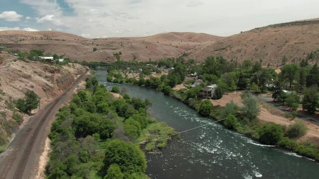 Aerial: The Deschutes River flowing through Maupin, Oregon, USA