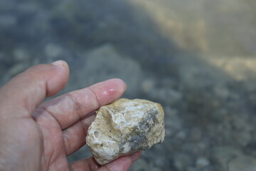 a woman holding a rock from the lake on Turin.