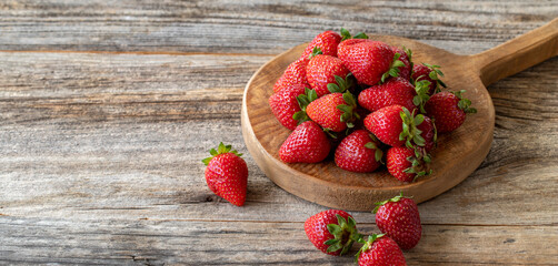 fresh strawberries on wood background. Copy space