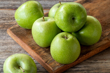 fresh green apple (sour apple) on wood background. Close up