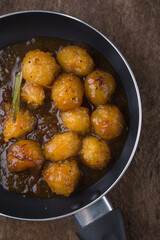 ambarella or june plum curry, vegetarian dish mixed in caramel and tempered with oil, onions, mustard seeds and cinnamon, combination of sweet and spicy flavor cuisine