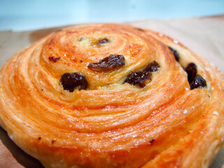 French traditional pastries. Pains aux raisins. On food paper bag
