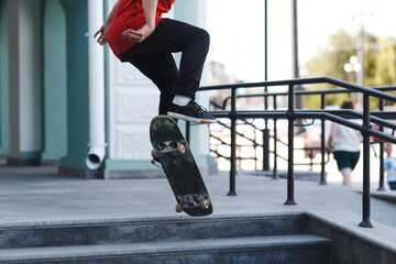 Young boy riding trick on skateboard in city.