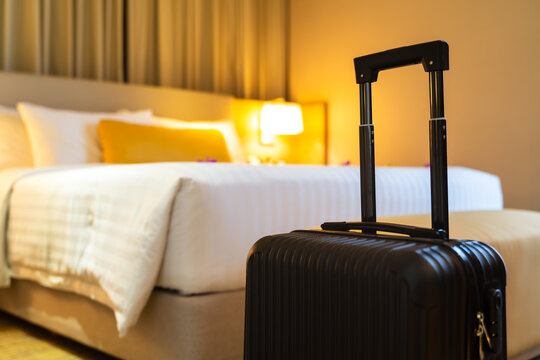 Suitcase and interior of hotel room