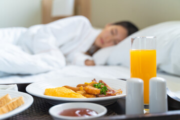 Breakfast in bed. Woman sleeping on the bed wake up late