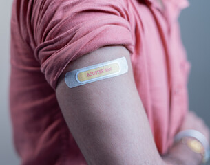 covid-19 or coronavirus vaccinated shoulder with booster shot sticker - concept of coronavirus 3rd...