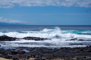 high waves crashing on rocks with sea spray