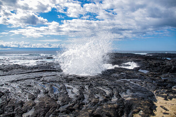 ocean waves crashing on lava rocks